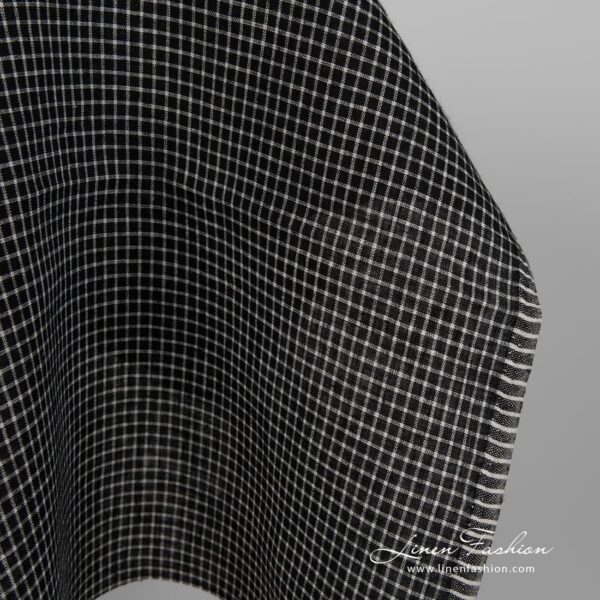 Black linen fabric with white checks close up edge view