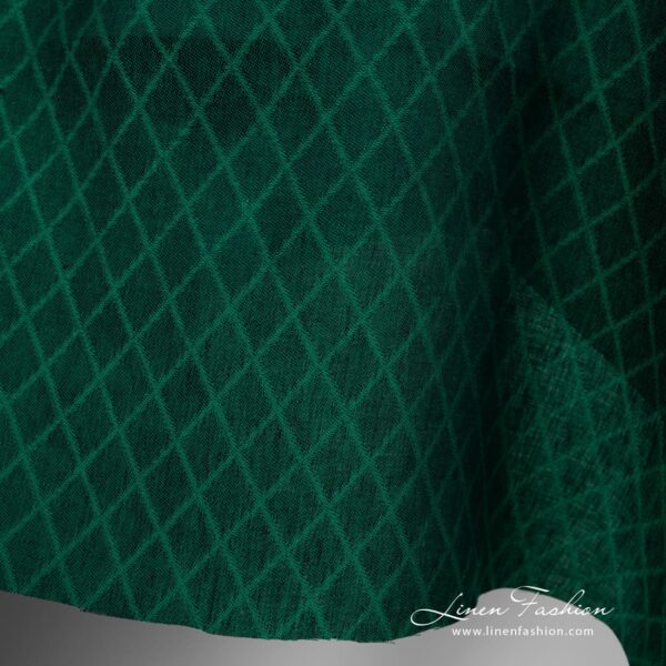 Linen fabric green colour rhombus pattern close up edge view