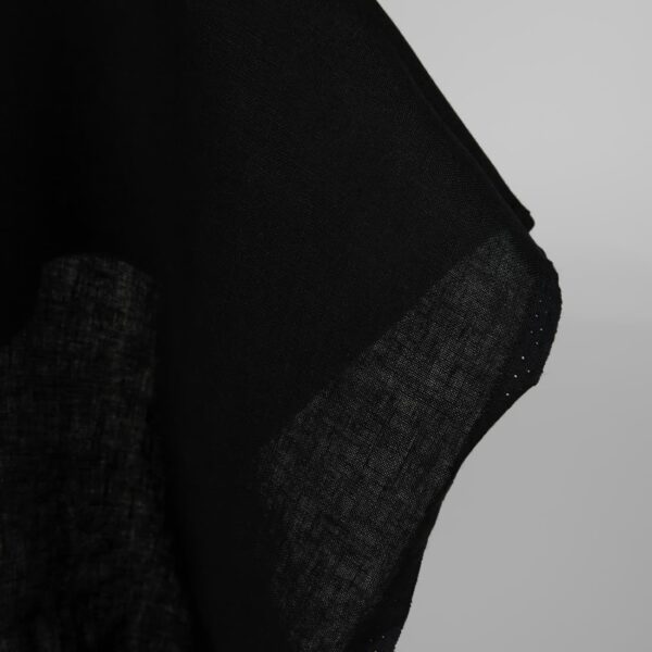 Heavy linen fabric black colour close up edge view