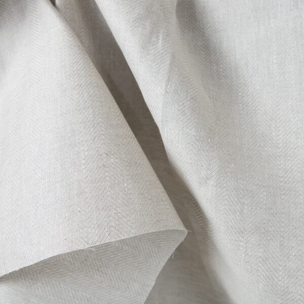 Linen fabric beige in herringbone pattern close up detail